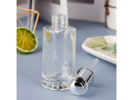 Flacon compte-goutte transparent à bouton poussoir