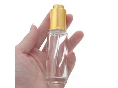 Flacon compte-goutte transparent à bouton poussoir
